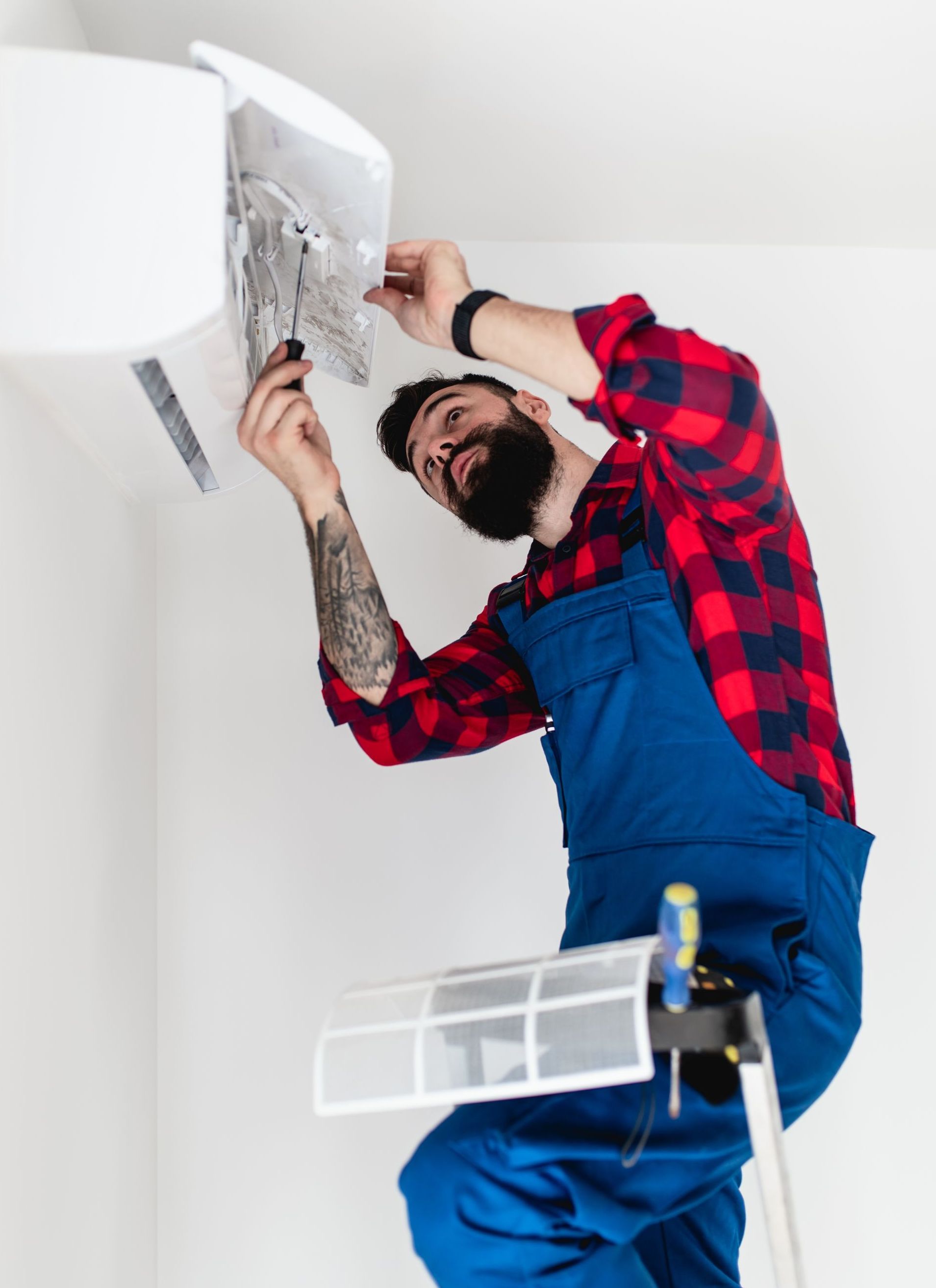 handyman repairing air conditioner