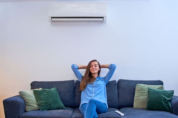 woman using air conditioner