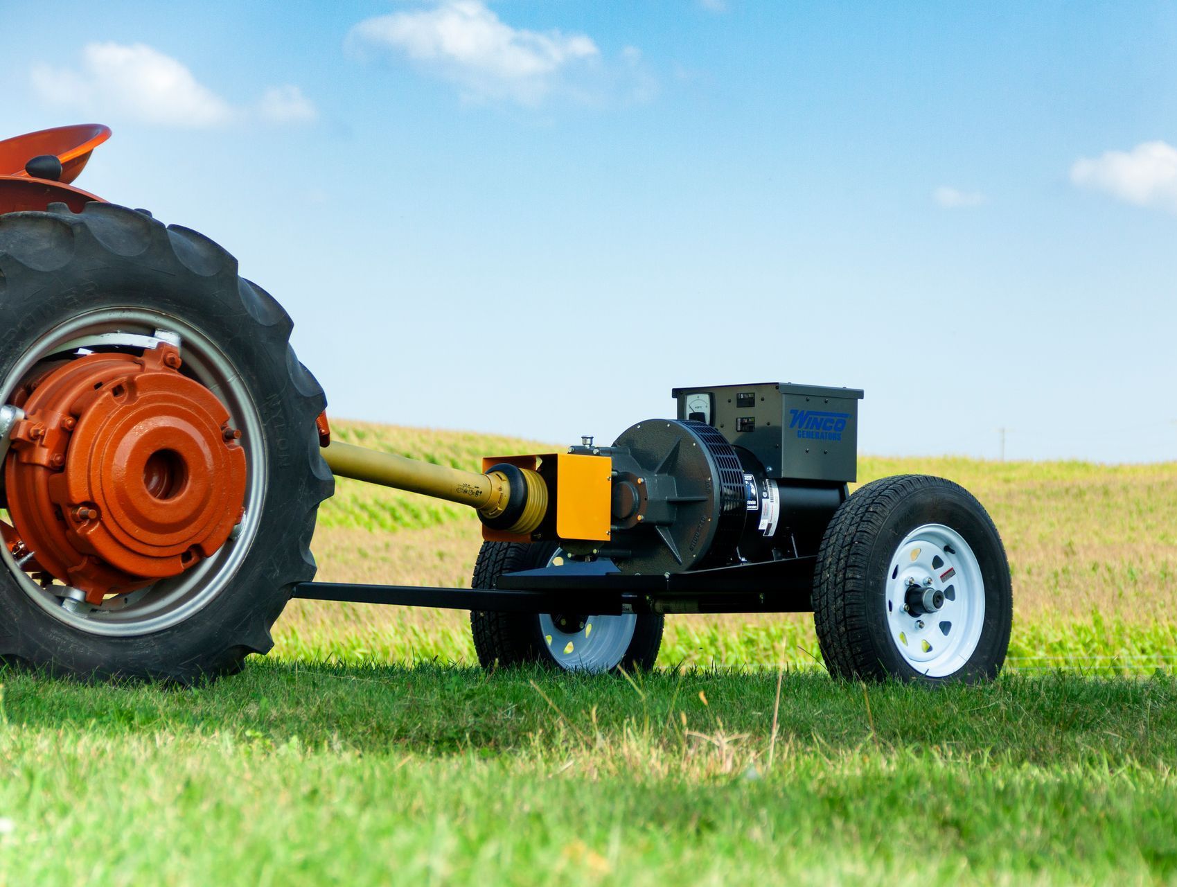 A tractor is pulling a smaller tractor in a field.
