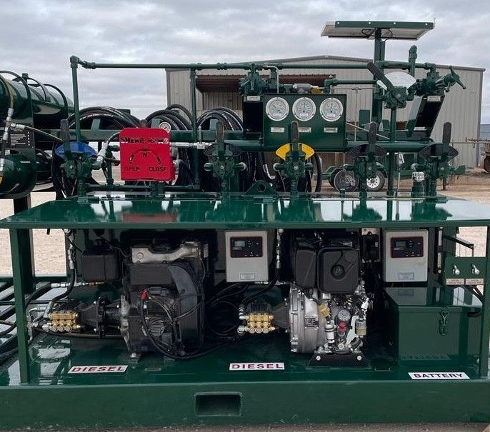 A green machine is sitting in front of a building.