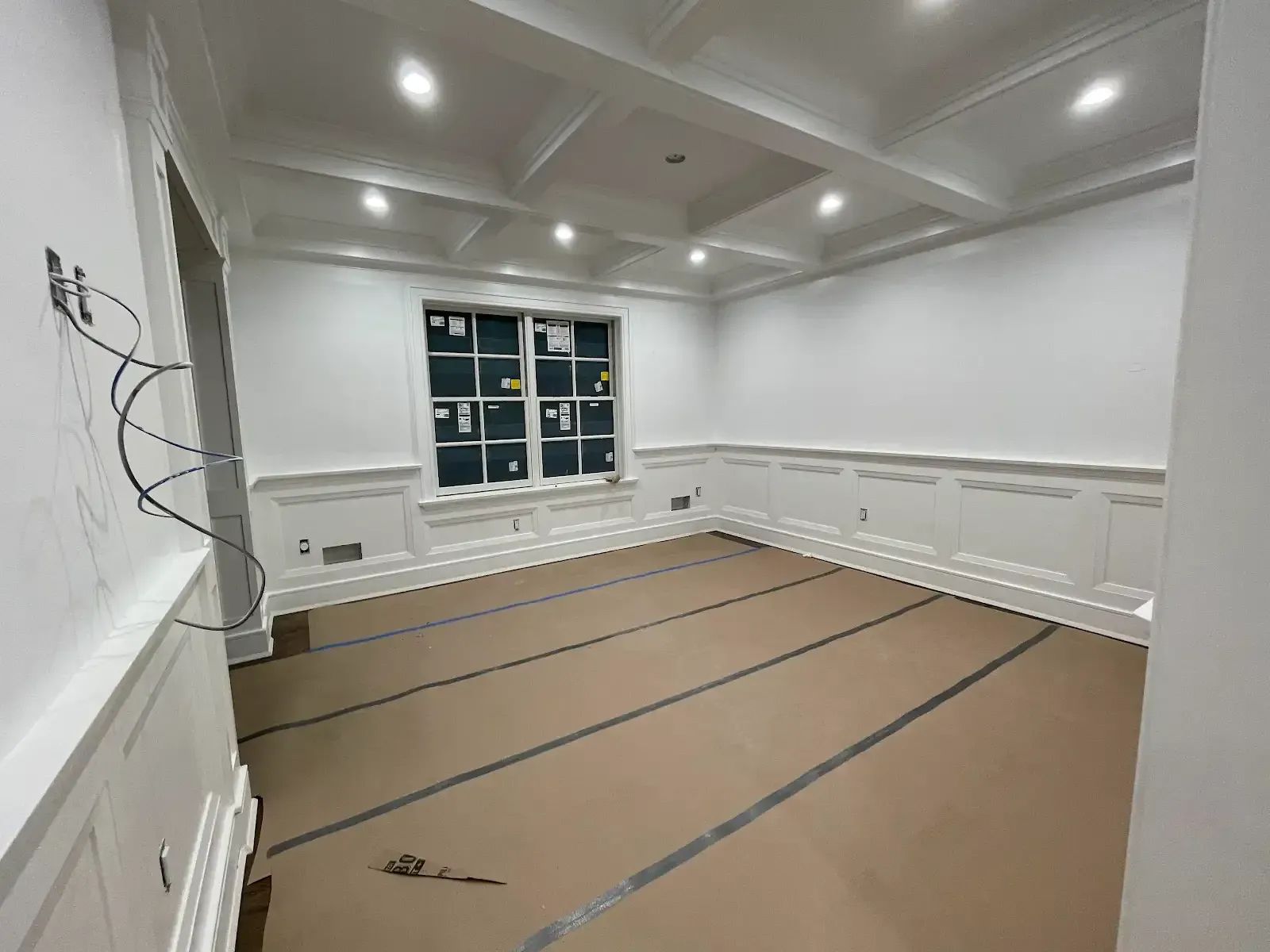 An empty room with white walls and a window