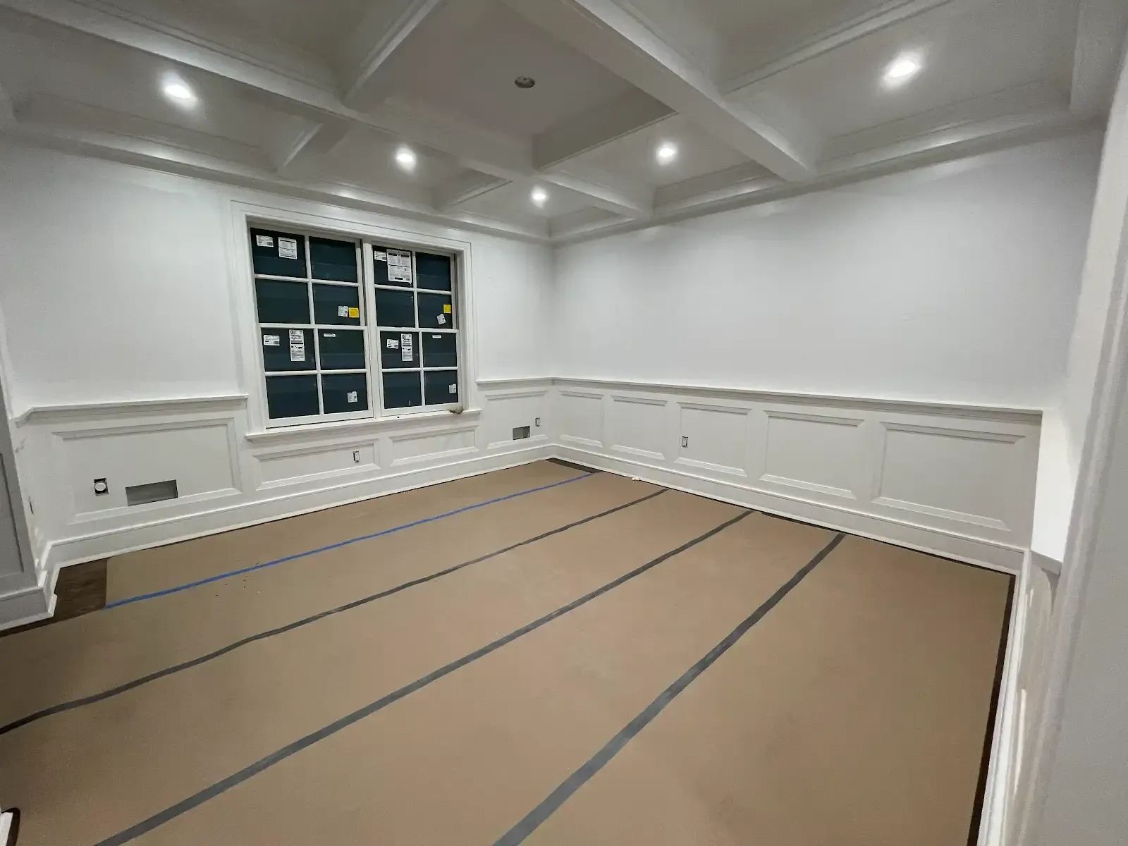 An empty room with white walls and a wooden floor