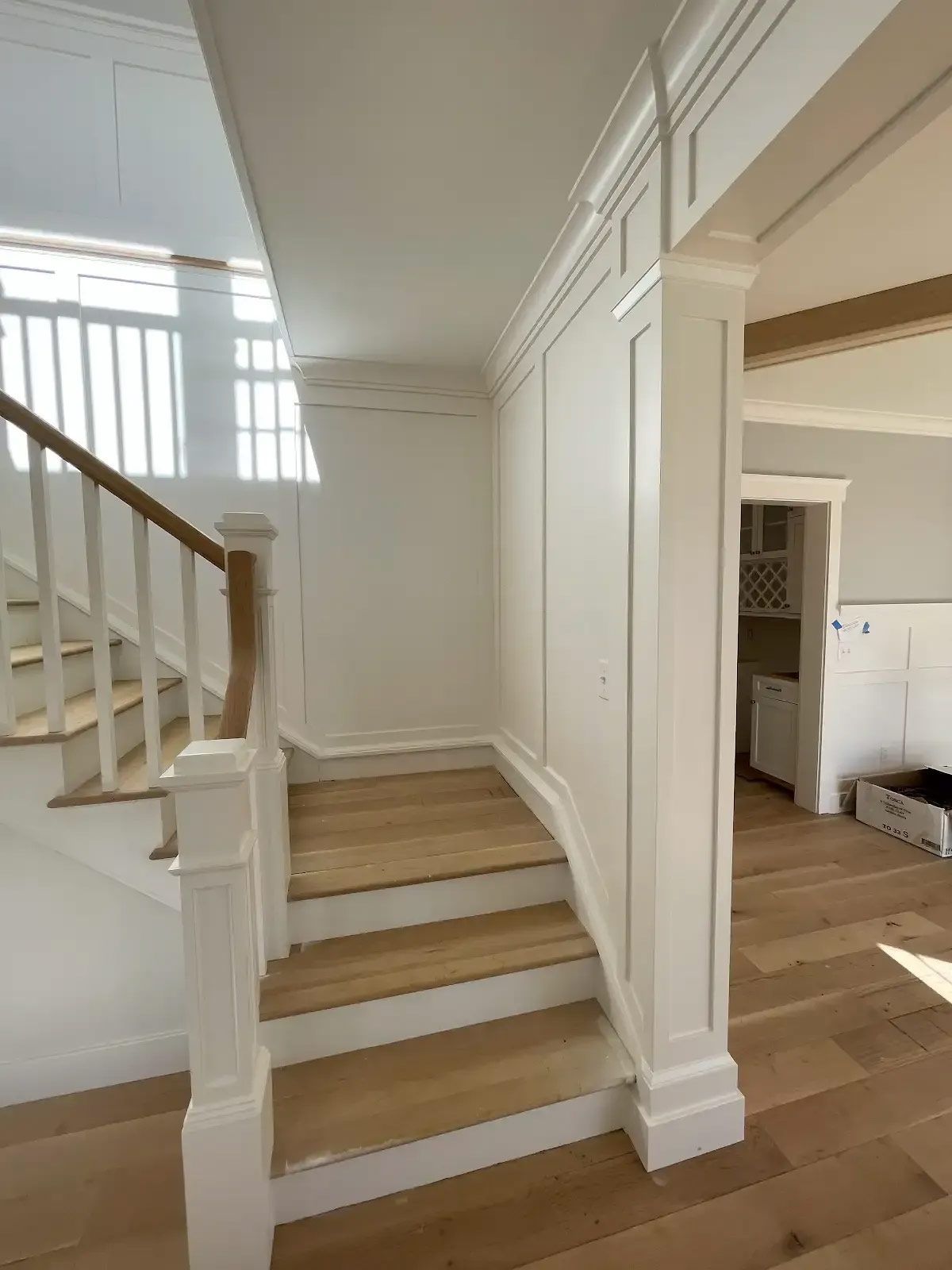 A staircase with wooden steps and a white railing in a house