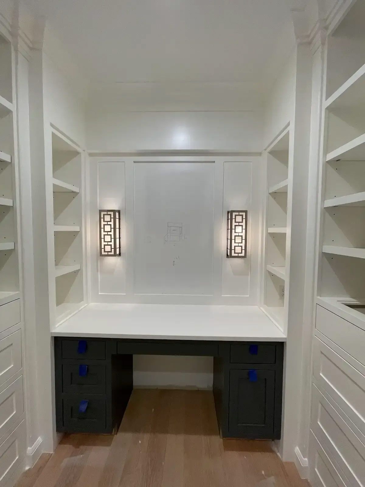 A closet with a desk and shelves in it