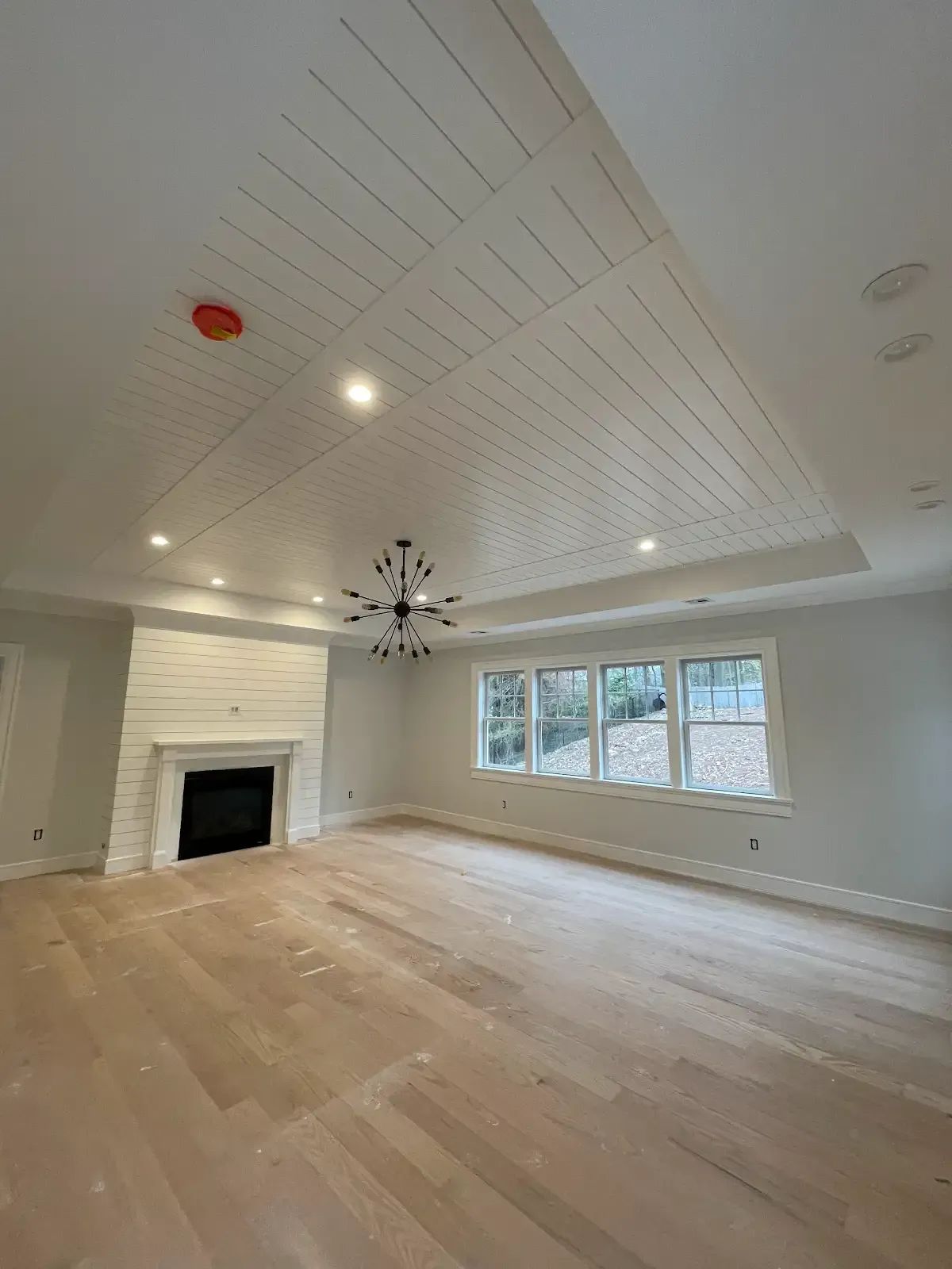 There is a fireplace in the middle of the room