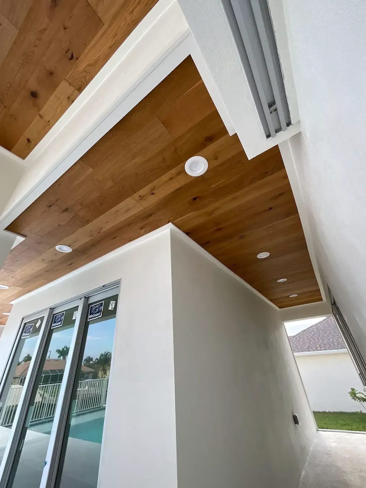A room with a wooden ceiling and white walls
