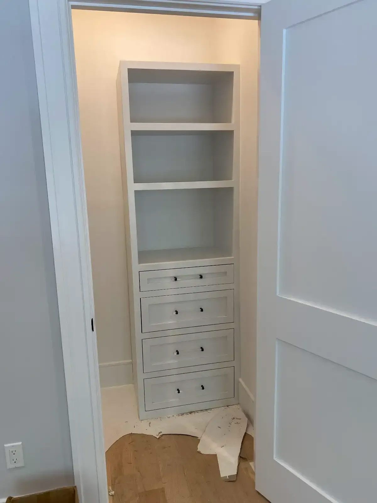 A closet with a bookshelf and drawers in it