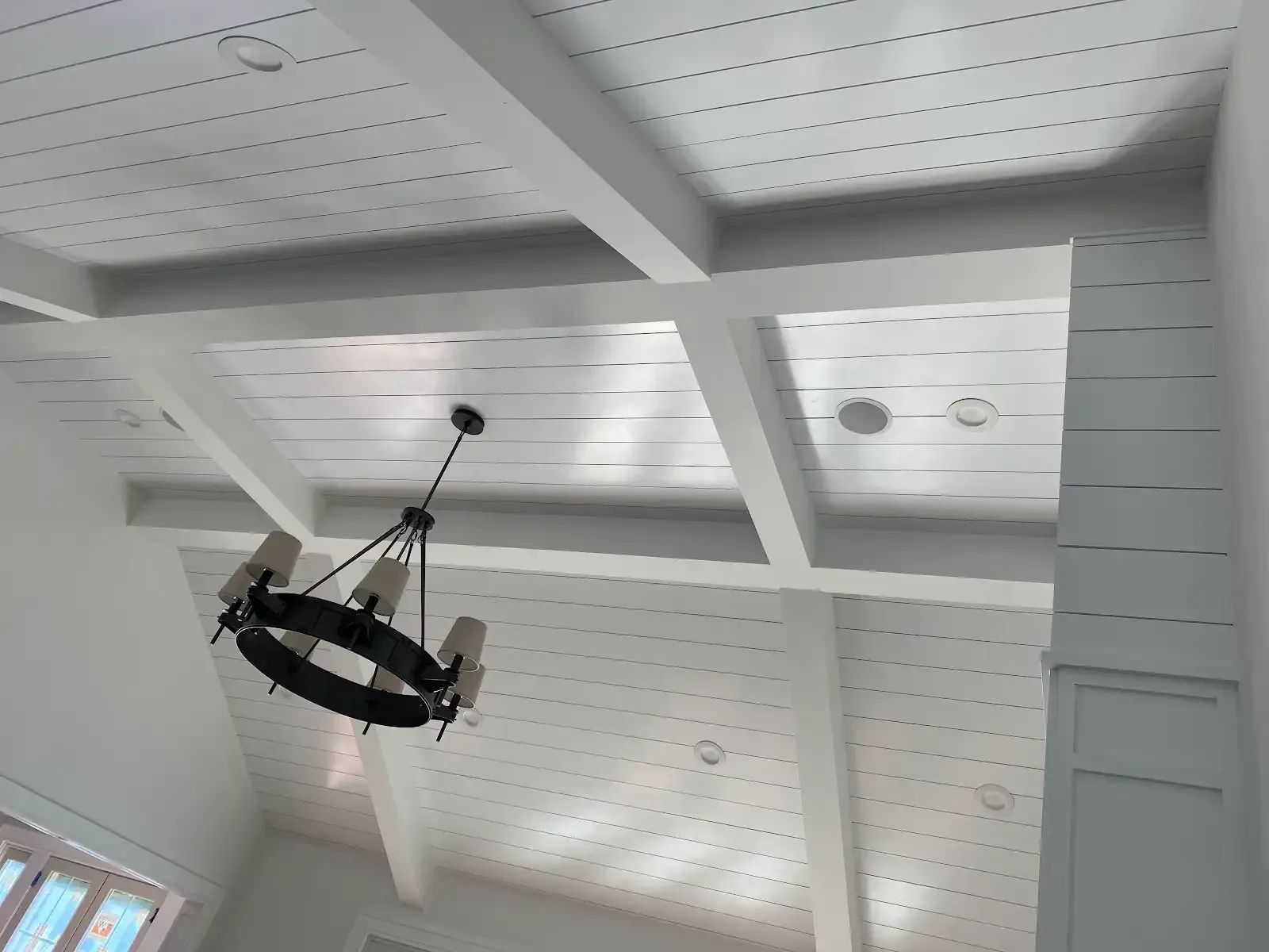 A chandelier is hanging from the ceiling of a room