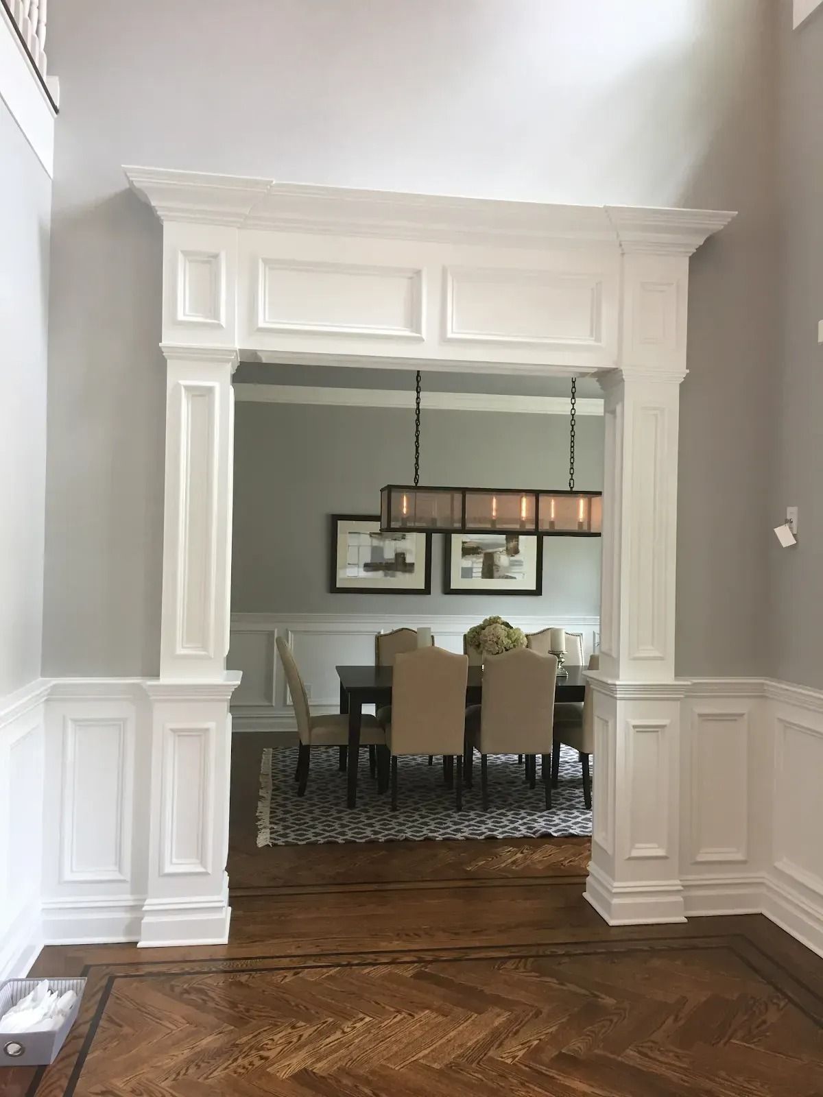 A hallway leading to a dining room with a table and chairs