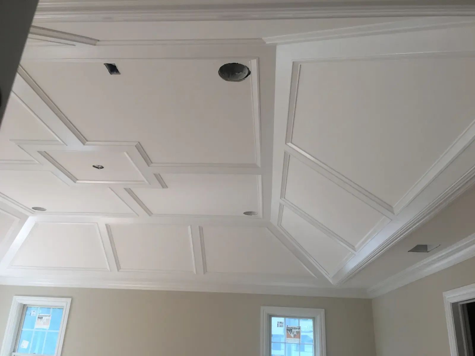 A room with a white ceiling and a window