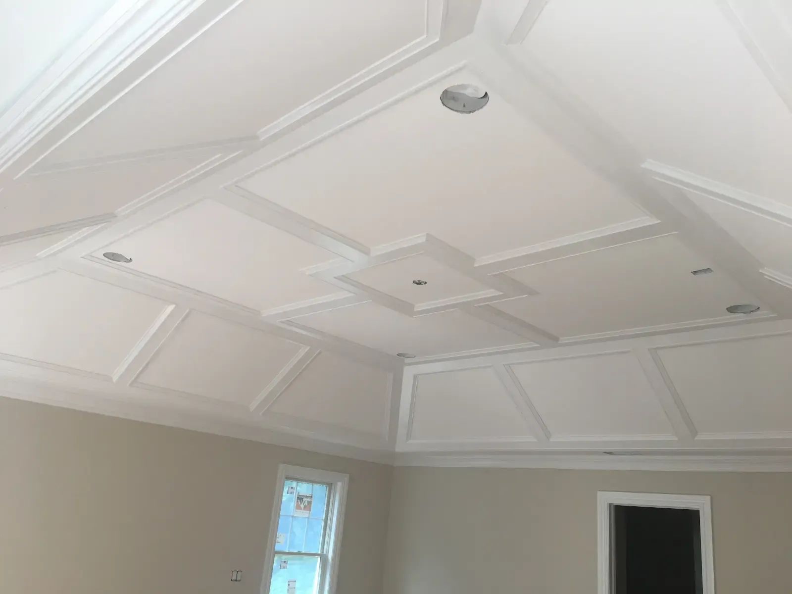 A room with a white ceiling and a window