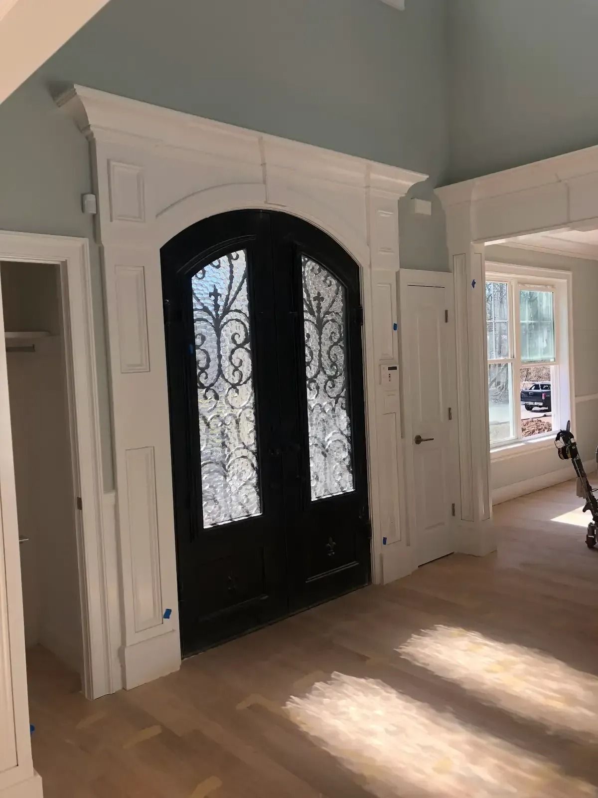 There is a black door in the middle of the room