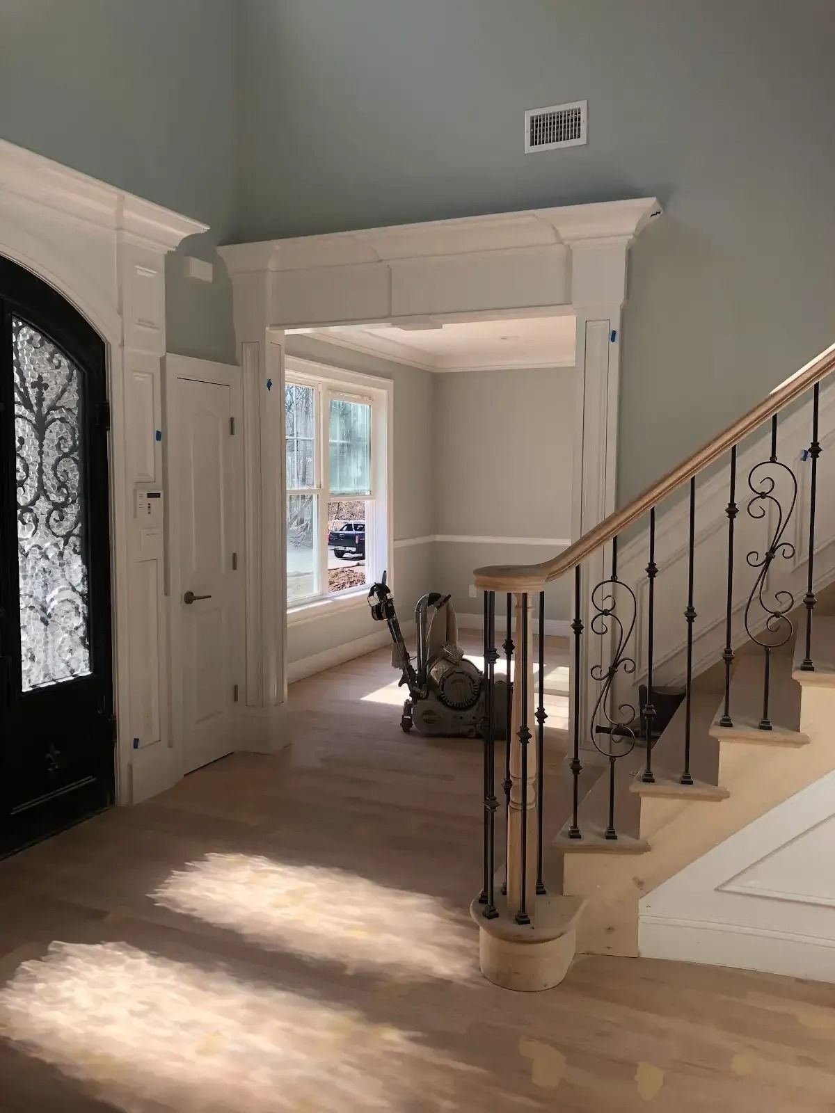 A hallway with stairs leading up to a living room