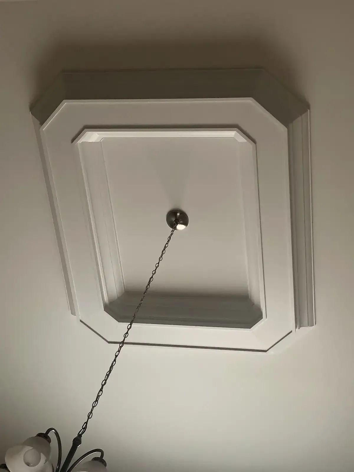 A light fixture is hanging from the ceiling of a room