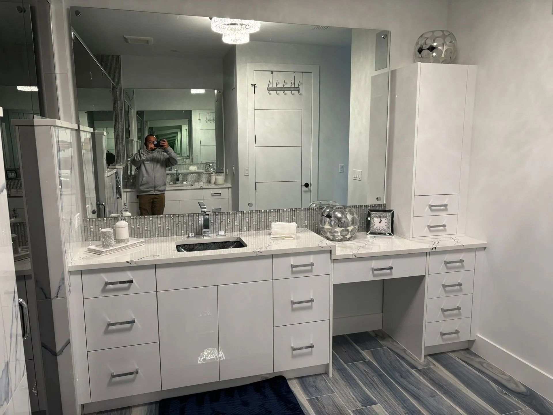 A bathroom with two sinks and a large mirror