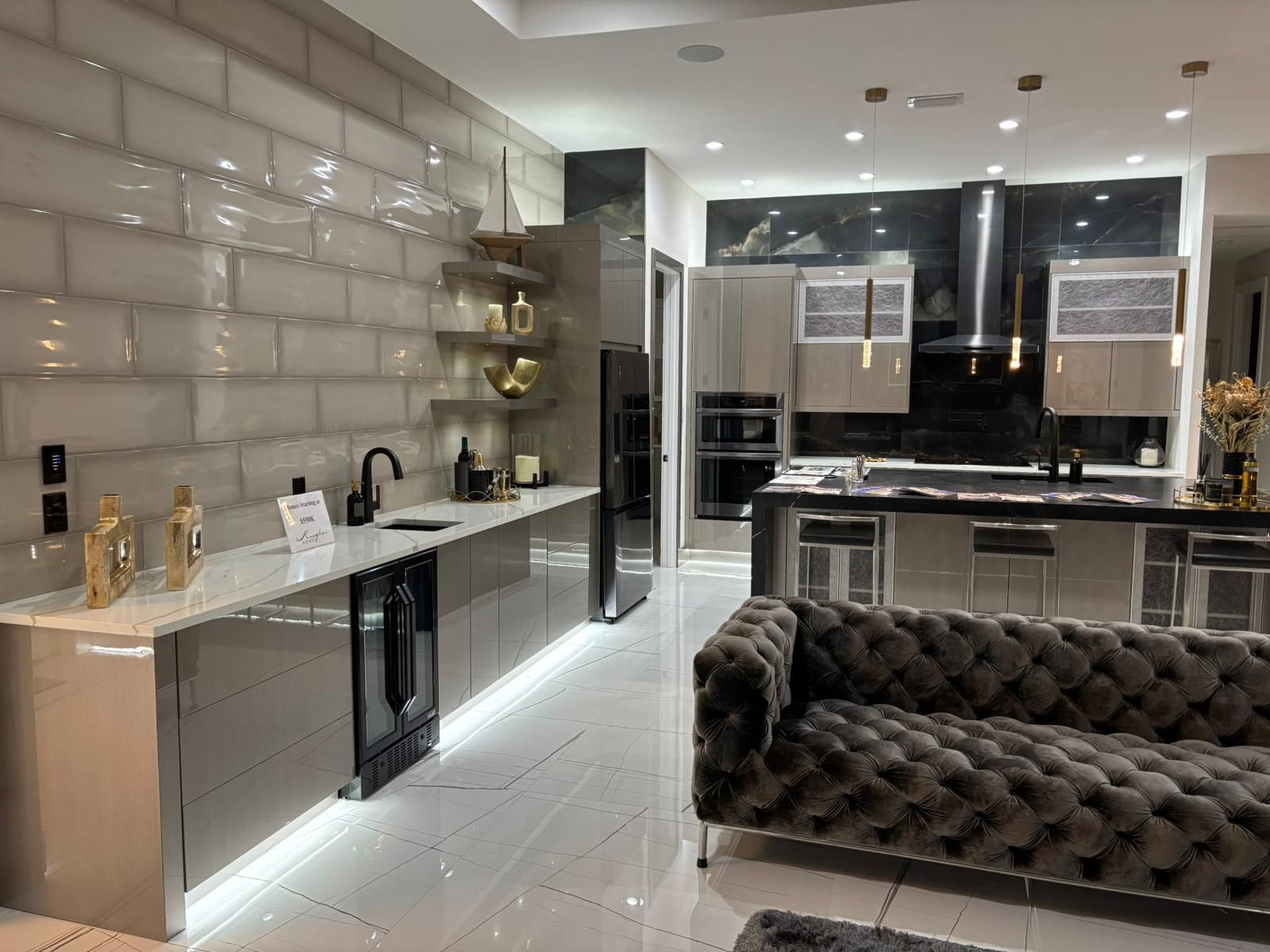 A living room with a couch and a kitchen in the background