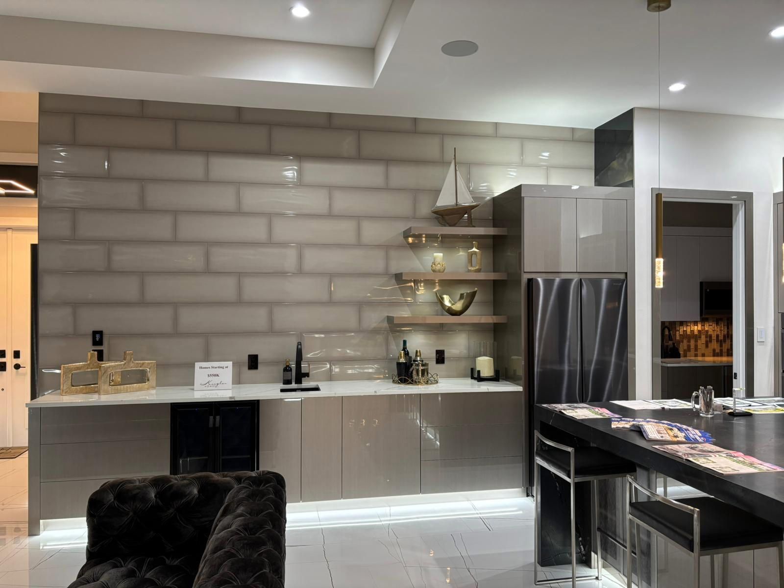 A kitchen with a brick wall and a table and chairs