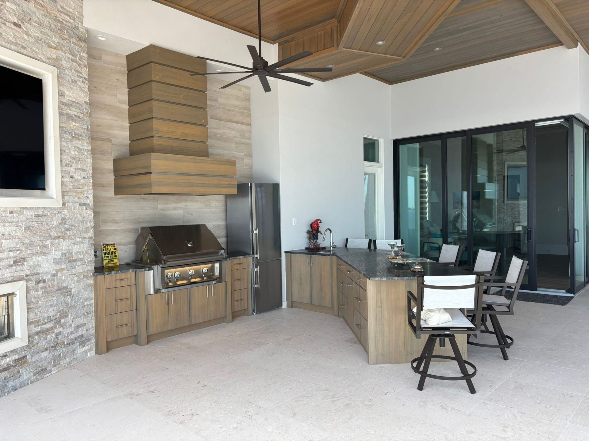 A kitchen with a grill and a ceiling fan