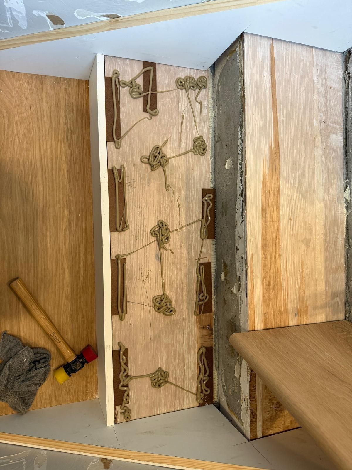 A wooden wall with a hammer and a brush on it