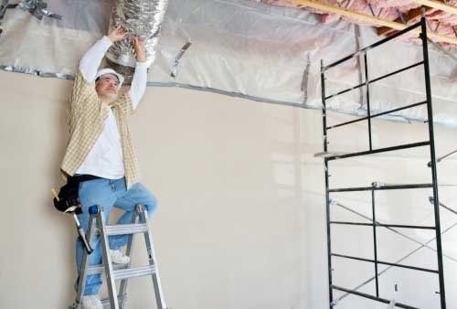 Architect on ladder working on ceiling - Building Remodeling Services in Grand Rapids, MN