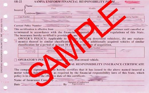 An empty room with dark wood flooring, tan walls, and three windows letting in sunlight, creating striped patterns.