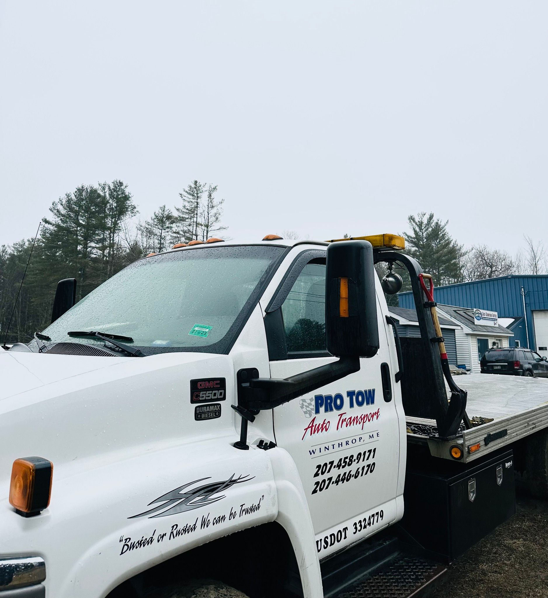 A white tow truck with the word pro tow on it