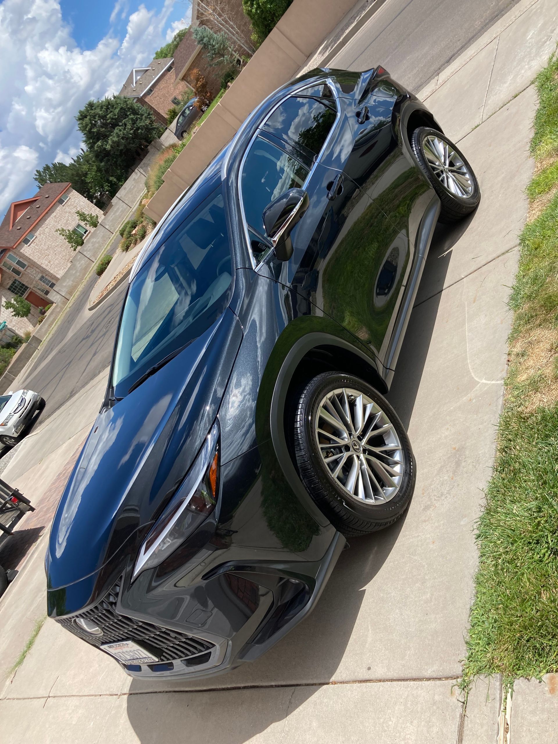 A black car is parked on the side of the road