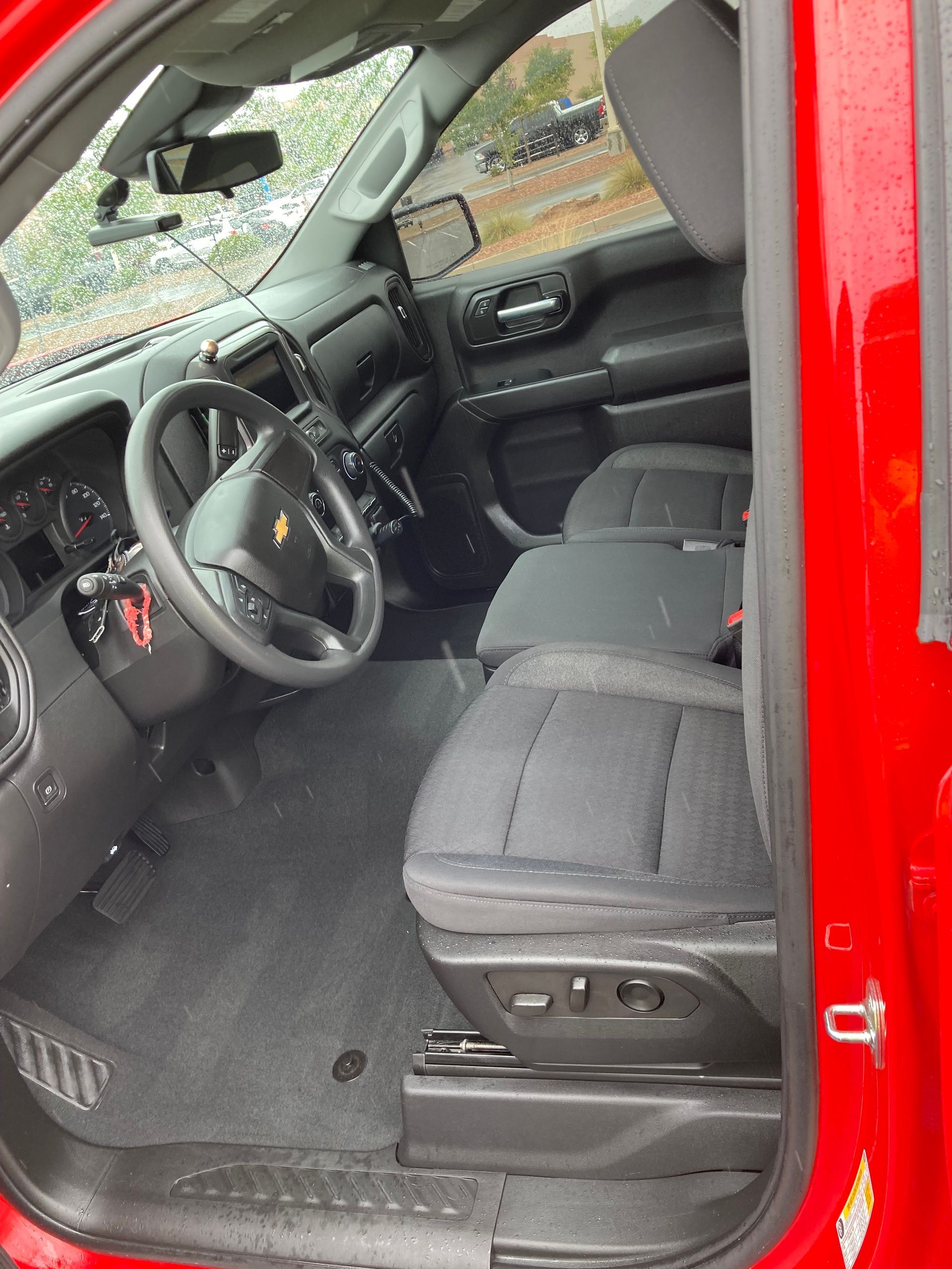 The inside of a red truck with the door open