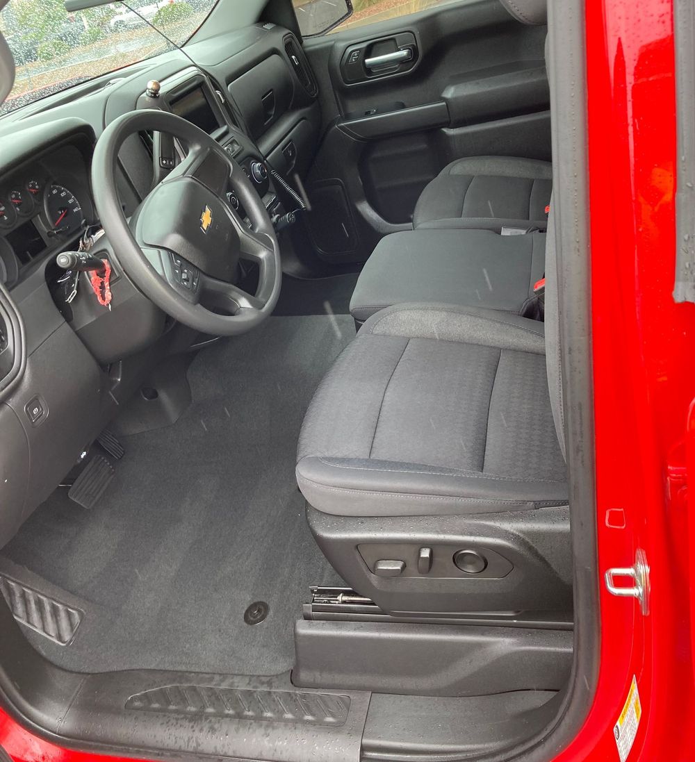 The inside of a red truck with the door open