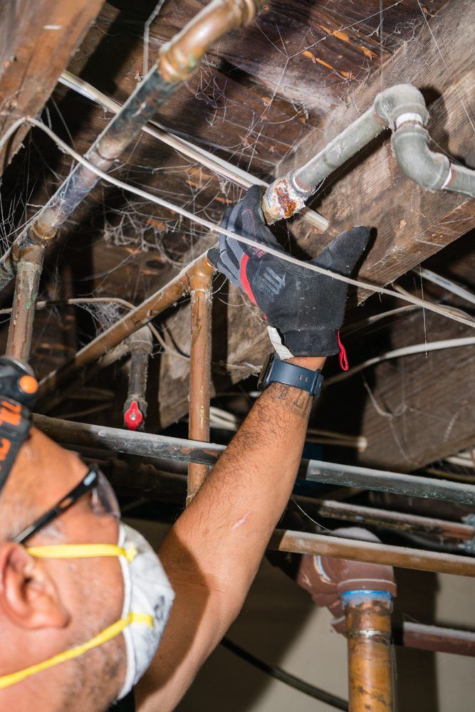 Man Inspecting Broken Pipe — Buffalo, New York — Buffalo Girl Home Inspection