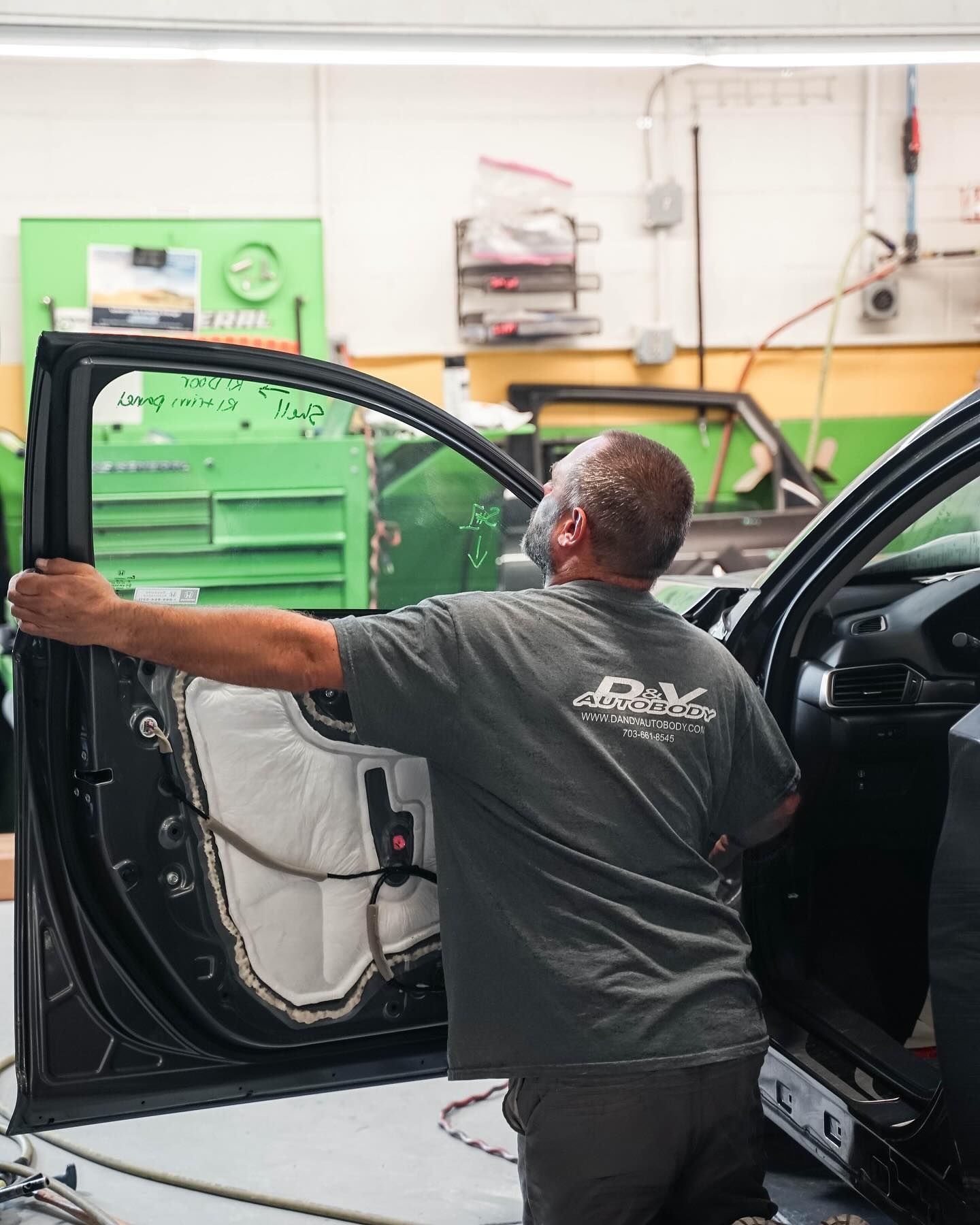 Technician Repairing Door Panel On Black Car | D&V Autobody Overland