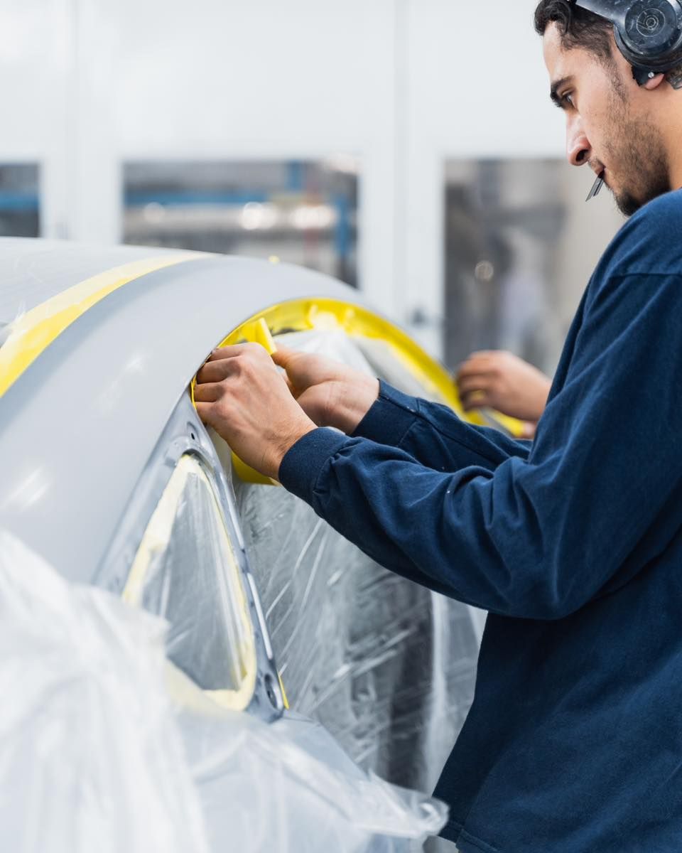 Technician Masking Yellow Car For Paint Job | D&V Autobody Overland