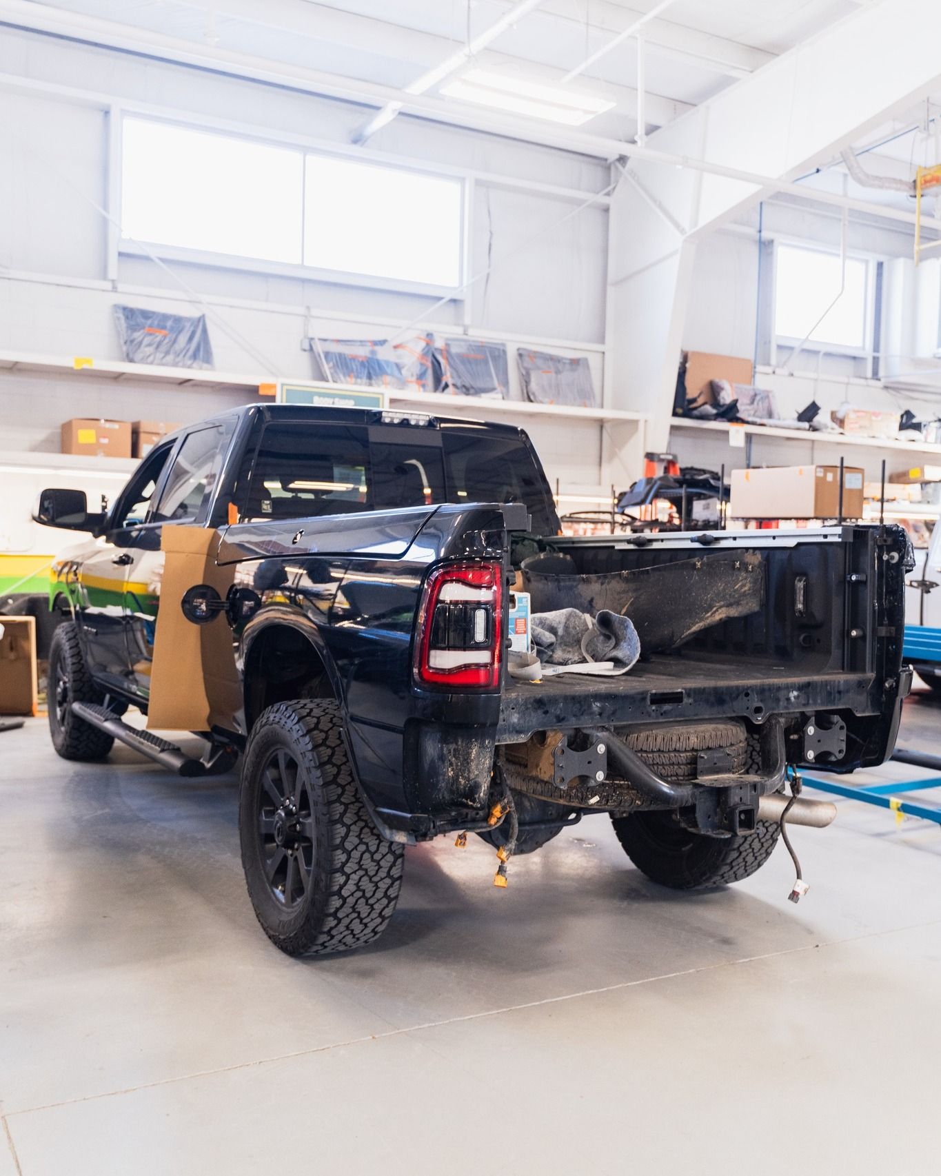 Black Pickup Truck Rear View Inside Auto Shop | D&V Autobody Overland