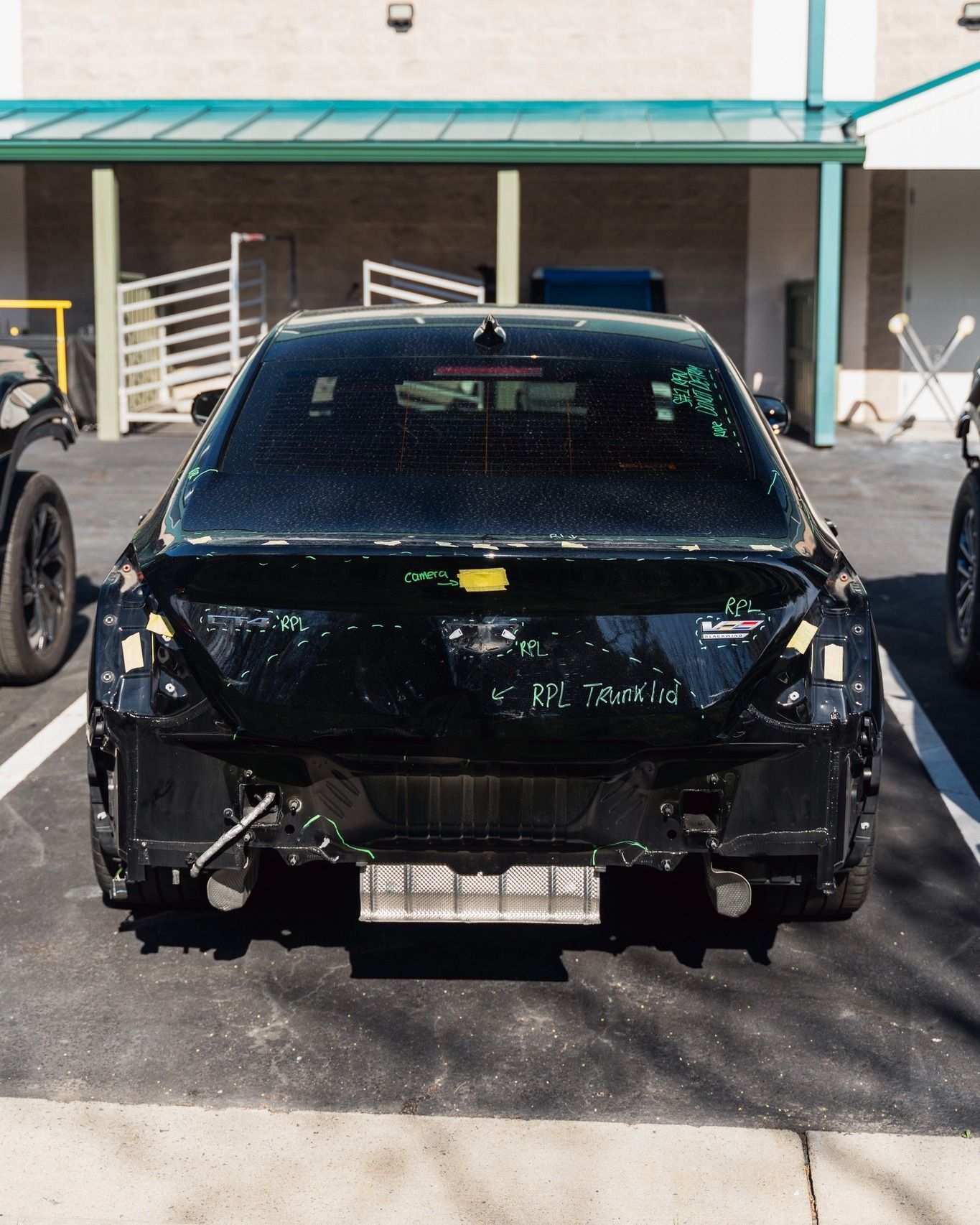 Black Sedan Rear View Parked Outside Shop | D&V Autobody Overland