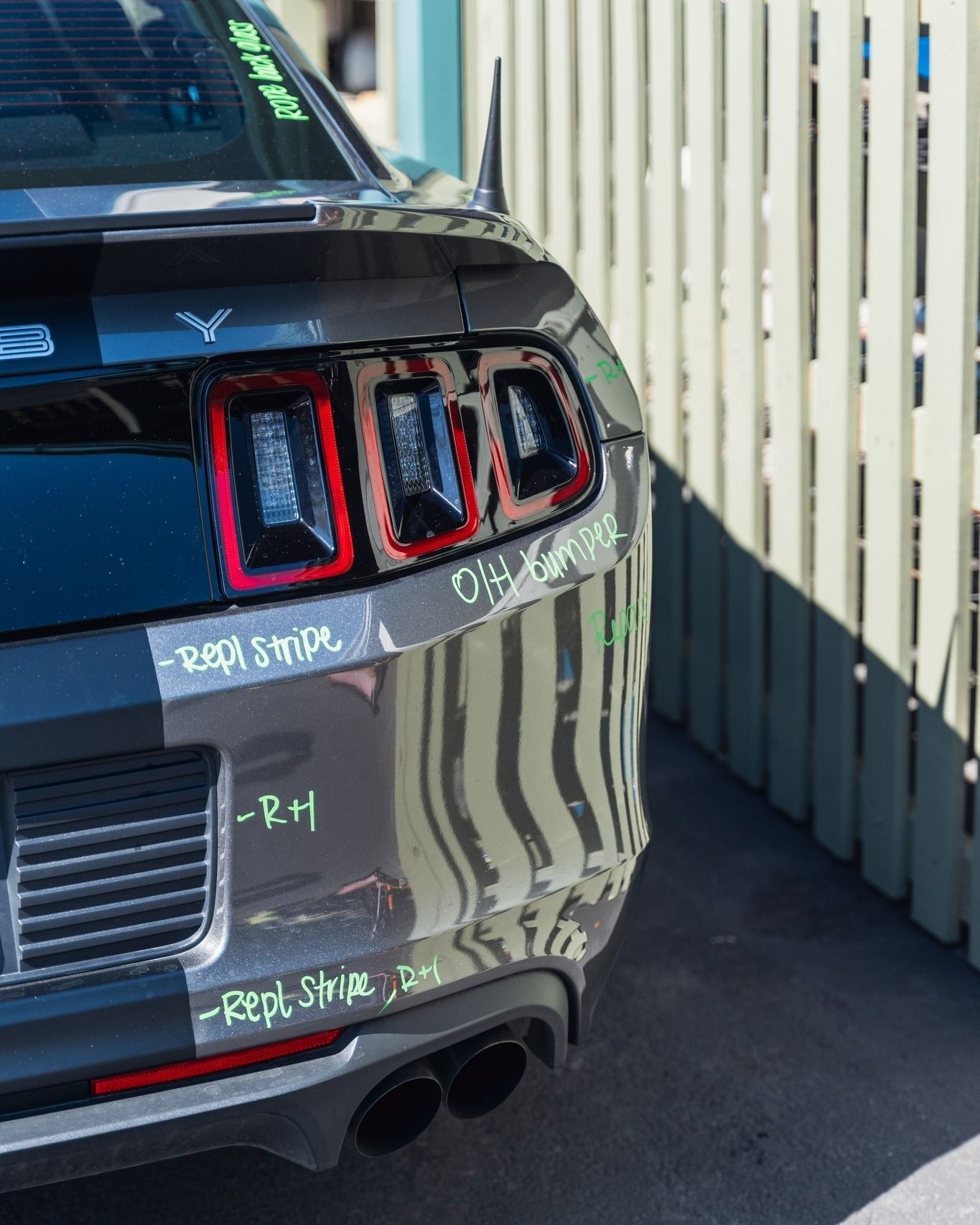 Black Ford Mustang Parked Beside Shop Wall | D&V Autobody Overland
