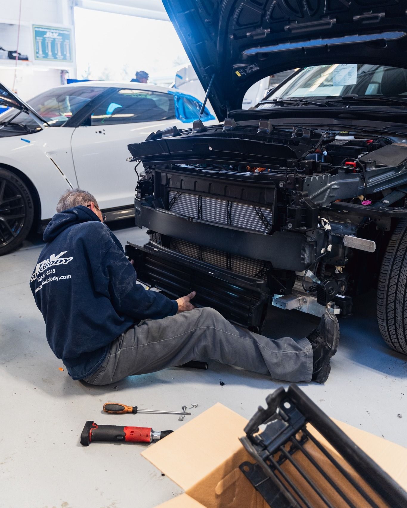 Mechanic Repairing Car Undercarriage On Shop Floor | D&V Autobody Overland