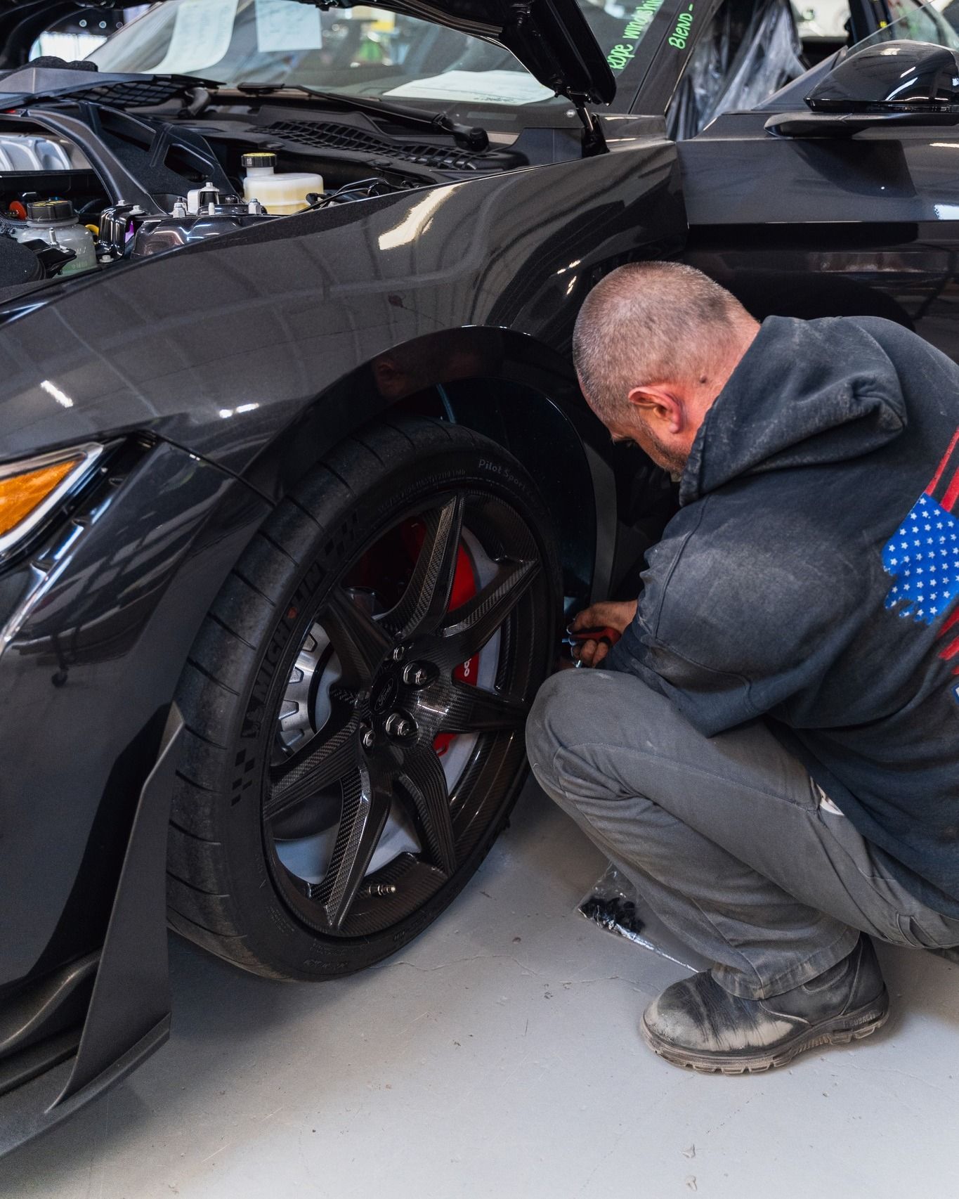 Mechanic Working On Black Car Wheel Alignment | D&V Autobody Overland