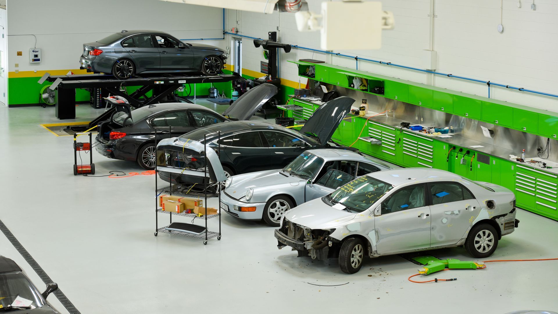 Auto Repair Shop With Silver Cars In Service Bays | D&V Autobody