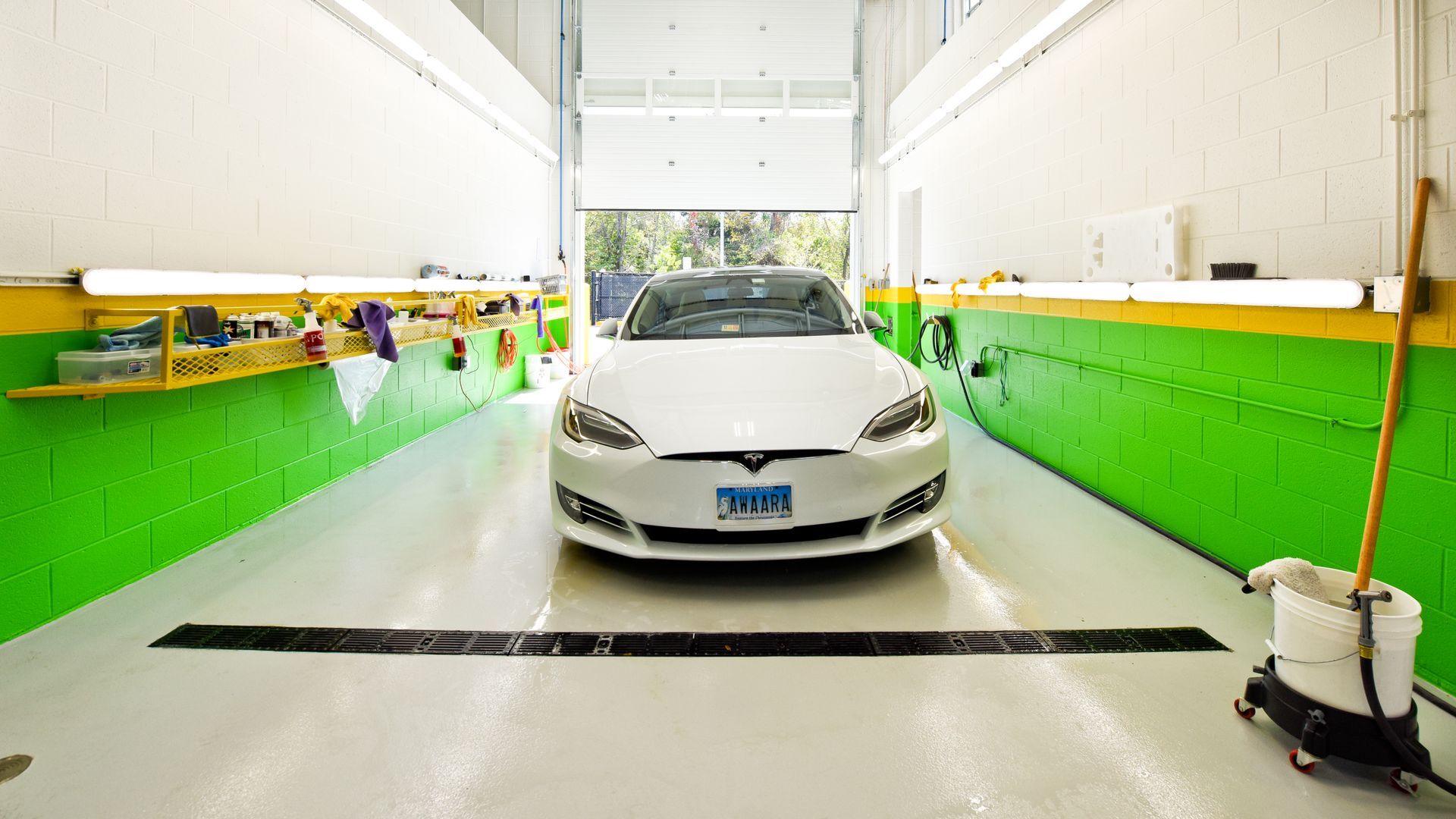 White Car Positioned At Entrance Of Shop Bay | D&V Autobody