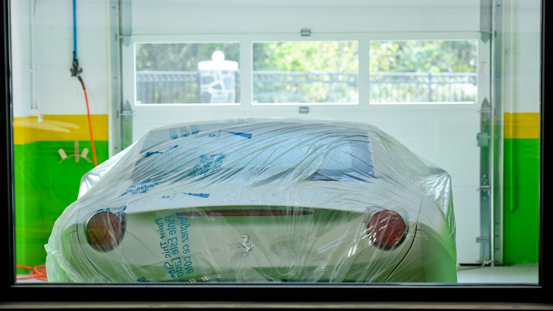 White Car Covered With Protective Plastic In Shop | D&V Autobody