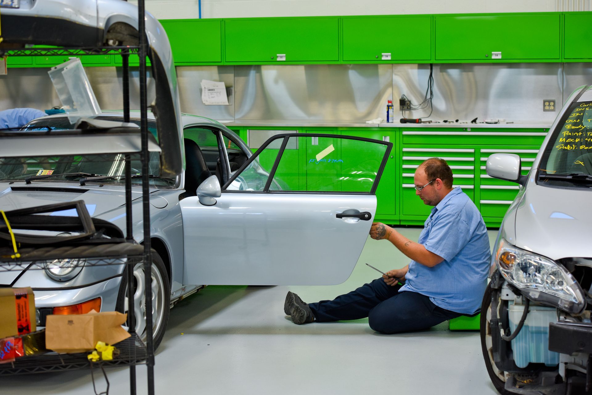 Technician Working On Car Door Panel Repair | D&V Autobody Masters