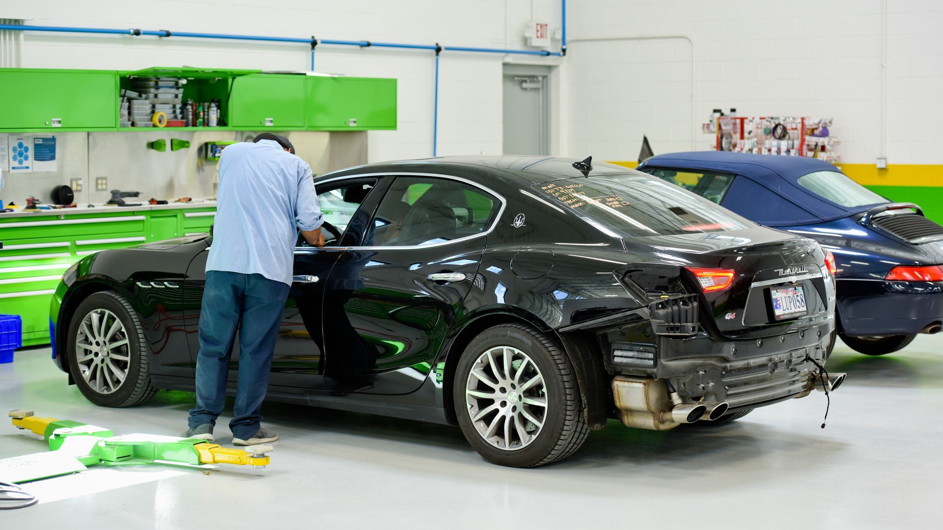 Technician Servicing Black Sedan Inside Auto Shop | D&V Autobody Masters
