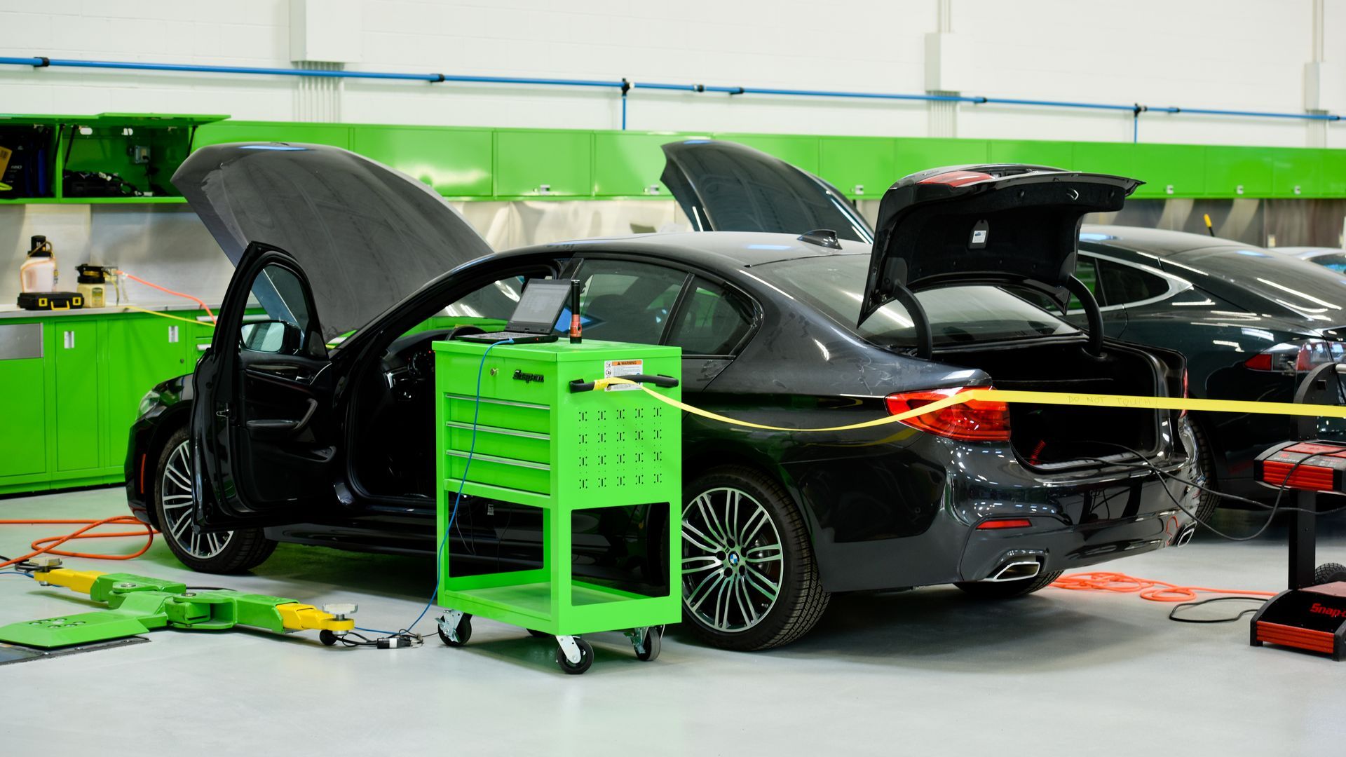 Mechanic Repairing Black Porsche On Shop Floor | D&V Autobody Masters