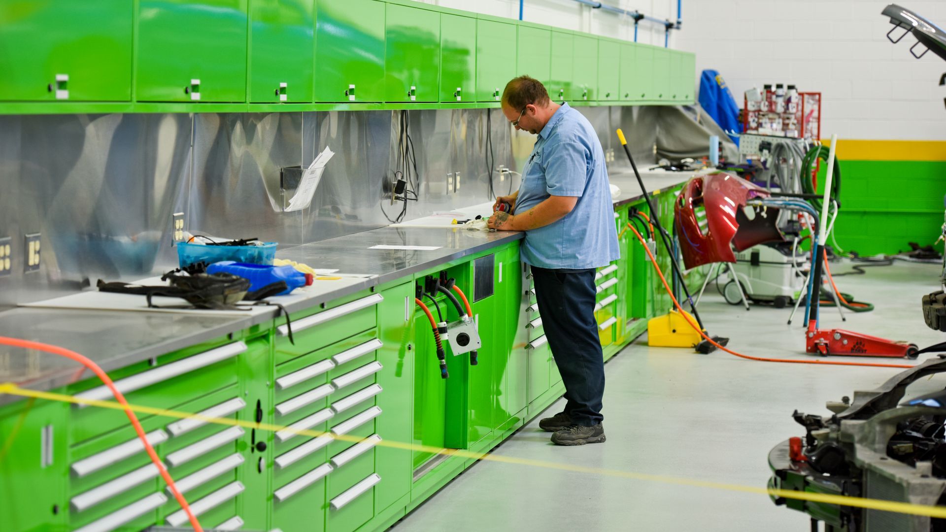 Technician Organizing Tools At Auto Shop Workbench | D&V Autobody
