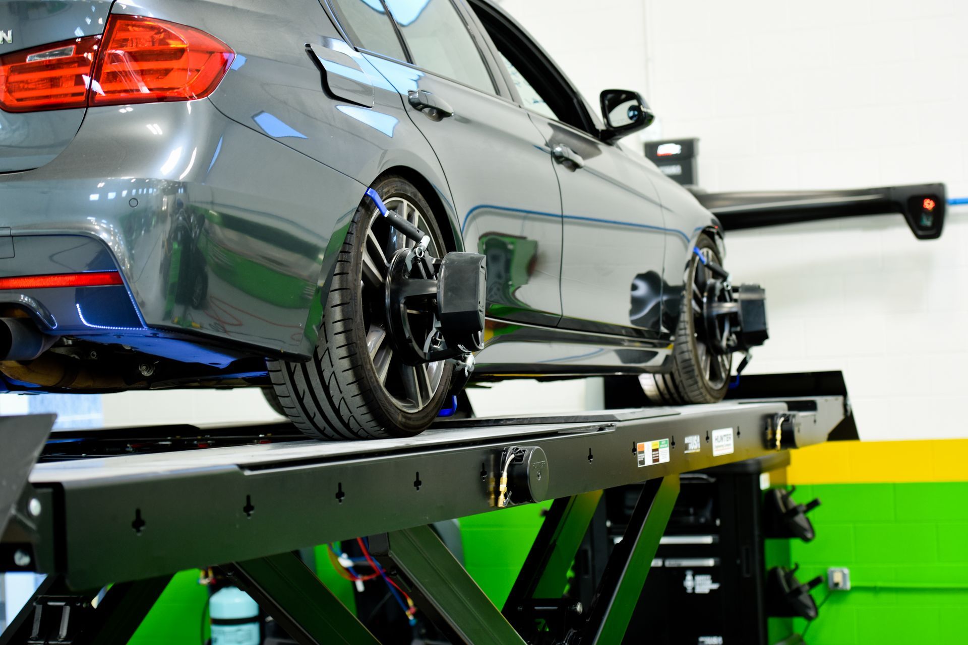 Silver Car On Lift For Alignment Service | D&V Autobody