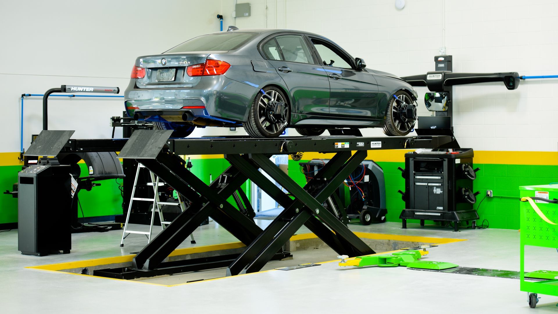 Gray Car On Lift In Auto Repair Shop | D&V Autobody