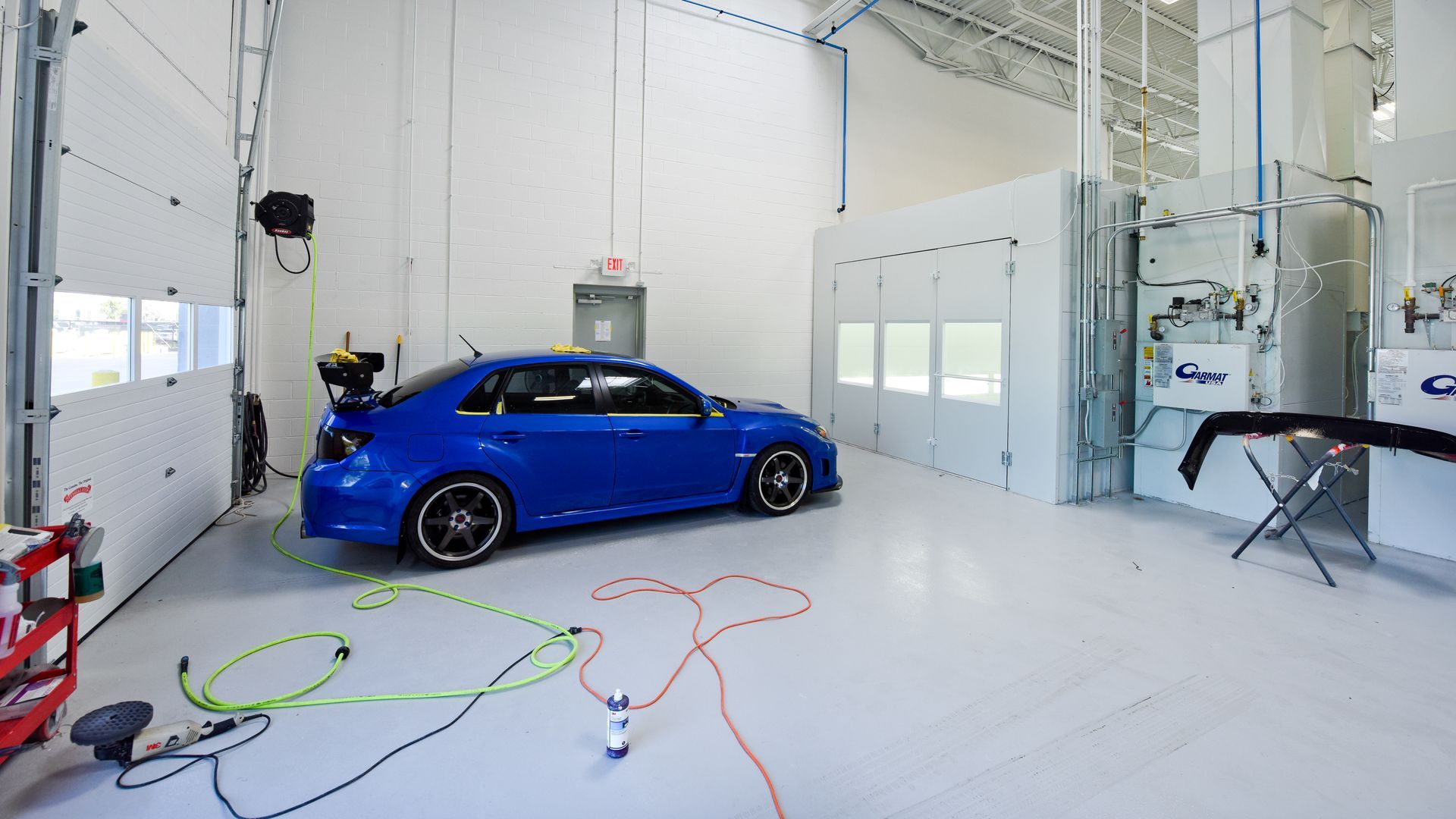 Blue Sports Car Parked Inside Auto Body Booth | D&V Autobody