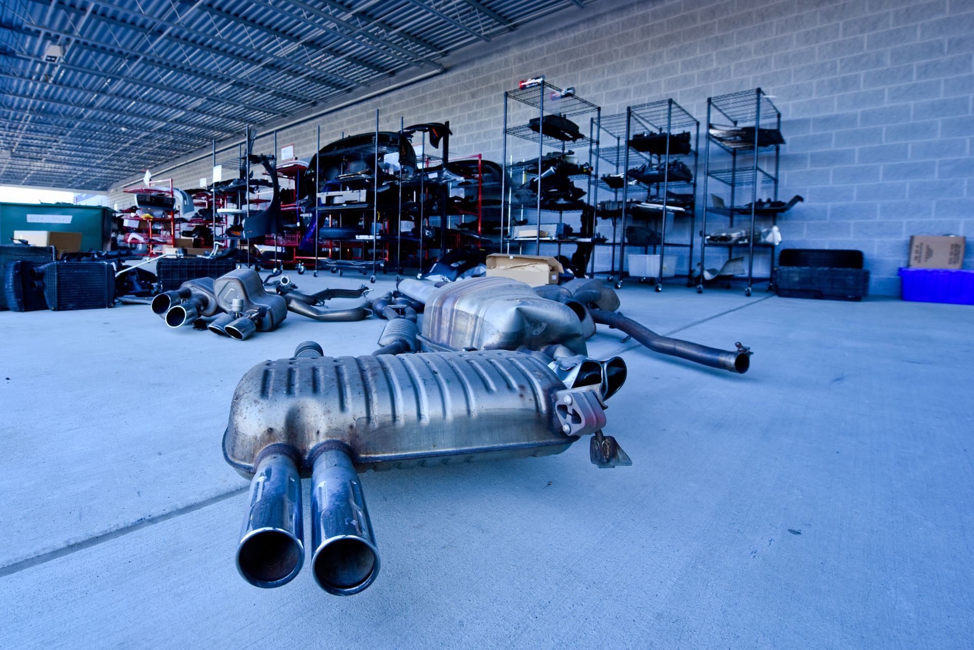Exhaust System Parts Displayed On Workshop Floor | D&V Autobody
