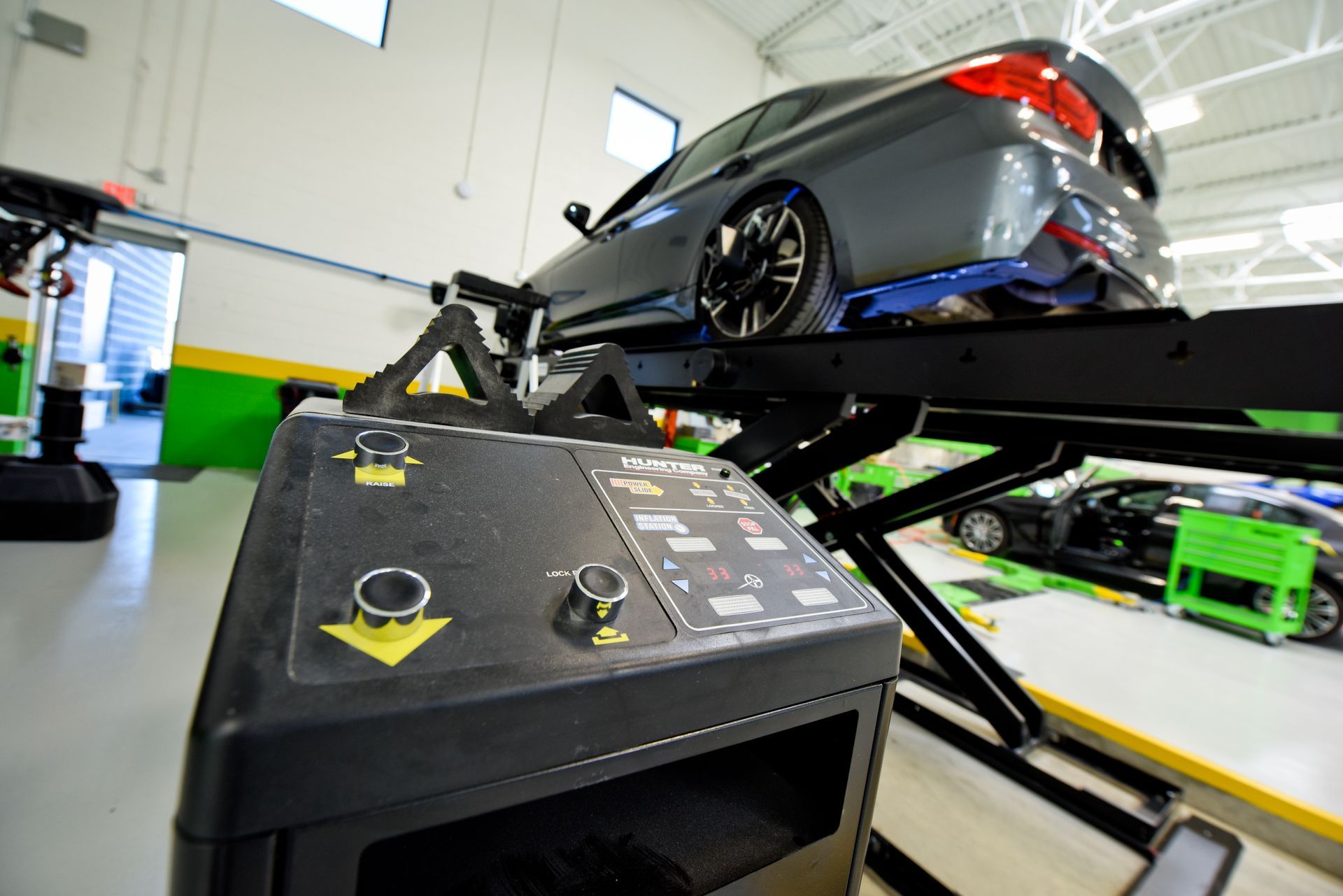 Car Lift Equipment With Controls In Workshop | D&V Autobody