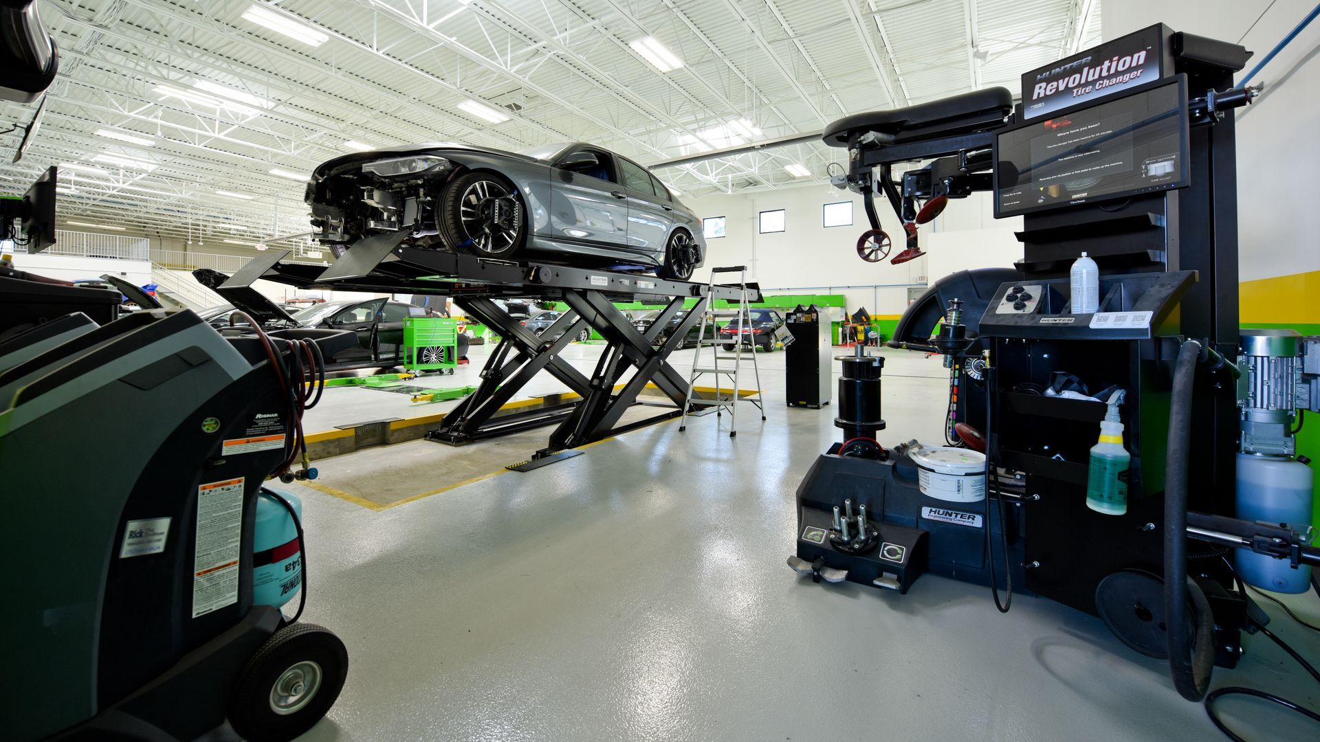 Multiple Cars Lifted On Shop Platforms For Service | D&V Autobody